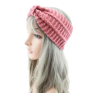 Pink knitted headband for women, warm winter hair band, casual twisted ear warmer accessory.