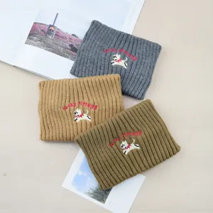 Detailed view of the cute puppy embroidered knitted headband, cozy wool winter hair band.