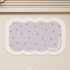 Cute purple polka dot bath mat close-up, soft absorbent material with scalloped wavy edge.