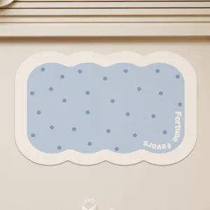 Cute scalloped bath mat with blue polka dots, soft absorbent non-slip floor mat for home.