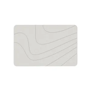 Close-up detail of the modern minimalist diatomaceous earth bath mat with soft wave texture.