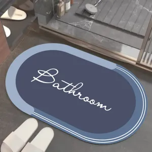 Vue détaillée du tapis de bain ovale bleu absorbant avec inscription, antidérapant.