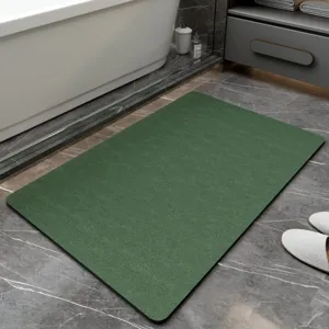 Green diatomite bath mat detail, minimalist non-slip absorbent floor mat for bathroom.