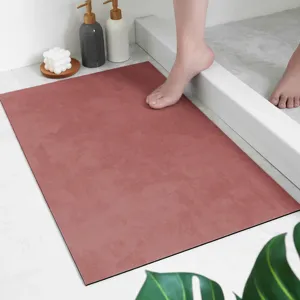 Absorbent bathroom floor mat detail showing soft dusty rose surface and anti-slip backing structure.