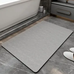 Grey diatomaceous earth bath mat detail, non-slip floor mat for modern bathroom interior.