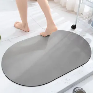 Grey oval bath mat in use showing quick-drying absorbent surface for modern bathroom floor decor.
