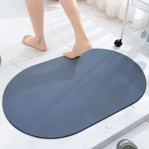 Dark blue oval diatomaceous earth bath mat for bathroom quick dry floor absorbent mat.