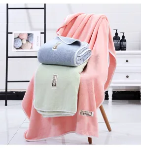 Suave y esponjosa toalla de baño de felpa coral, absorbente y gruesa con etiqueta de tela.