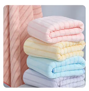 Soft absorbent coral fleece towel with vertical stripes, fluffy texture for daily face use.