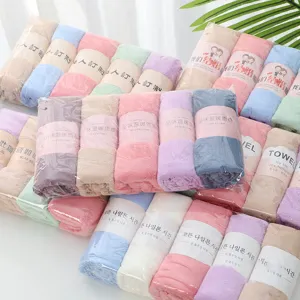 Detailed shot of soft colorful coral fleece towels rolled neatly with custom paper belly bands.