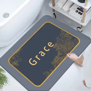 Vista detallada de alfombrilla de baño gris en tierra de diatomeas con estampado floral y Grace.