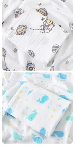 Double layer cotton gauze baby swaddle blanket, cartoon space and cute whale print details.