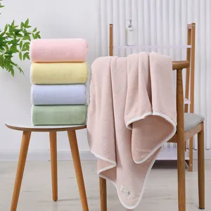 Soft coral fleece bath towel with piped edge, highly absorbent and comfortable home use.