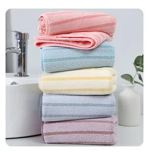 Soft coral fleece striped face towel detail showing absorbent plush fabric and neat stack.