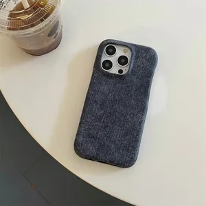 Close-up of dark denim phone case texture detail, showing stylish minimalist fabric design.