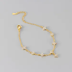 Vergoldetes Kleeblatt Zirkon Armband Detail, filigrane Kette mit glänzenden Zirkonia Anhängern.