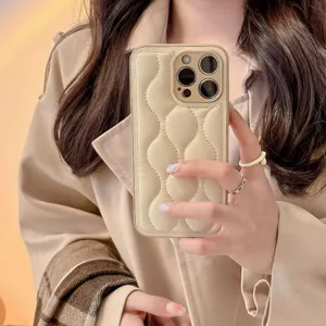 Detailed shot of trendy padded puffer phone case with stylish wave quilting design for apple.
