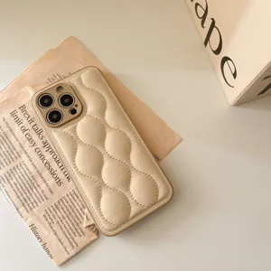 Beige puffer phone case with quilted texture for iPhone, stylish winter case.