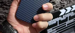 Carbon fiber pattern phone case detail shot showcasing slim texture and precise cutouts.