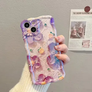 A detailed view of a stylish wavy silicone iPhone case featuring vibrant oil painting floral art.