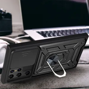 Close-up detail of rugged black phone case featuring camera slide cover and metal ring holder.