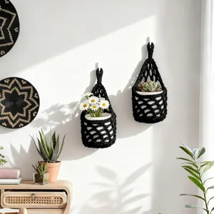 Handmade black macrame plant hanger, stylish wall hanging mesh pocket for home decor.