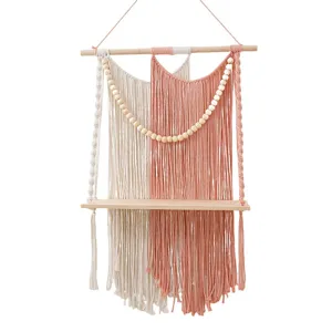 Macrame wall hanging shelf with wooden board and beads, handmade cotton rope decor for room.