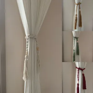 Handmade macrame curtain tieback with wooden beads and tassels, elegant boho decor detail.