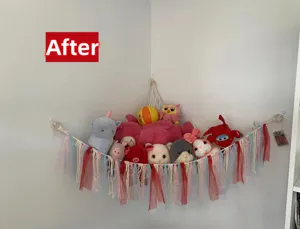 Handmade macrame toy hammock for kids room corner, cotton rope storage net with colorful ribbons.