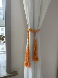 Handmade macrame cotton curtain tieback detail featuring natural wooden beads and gorgeous tassels.