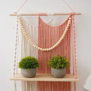 Nordic macrame wall hanging shelf with wooden beads and artificial potted plants for home decor