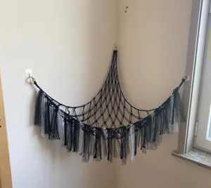Handmade black macrame toy hammock with sparkly tulle fringe for corner room plush storage