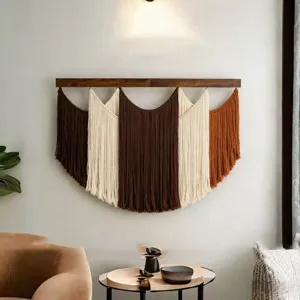 Detailed shot of a bohemian handmade woven wall hanging tapestry featuring a wooden rod.