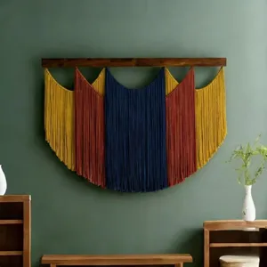 Bohemian macrame wall hanging detail, colorful yarn tapestry on wooden rod for home interior.