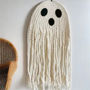 Detailed close-up of handmade macrame ghost wall hanging showing fine cotton rope texture.