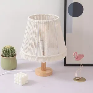 Bohemian macrame table lamp detail view, handmade cotton rope shade with wooden base decor.