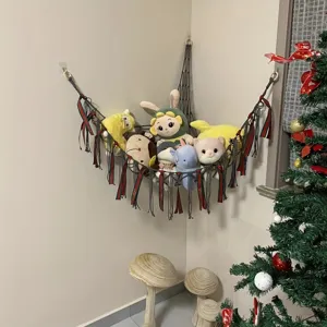 Corner toy hammock for kids room, hand-woven mesh storage net with tassels for plush toys.