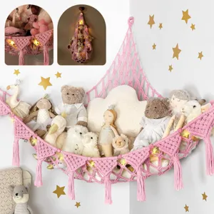 Handmade macrame toy hammock for corner, pink bohemian stuffed animal net with cute tassels.