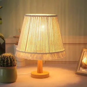 Handmade bohemian style table lamp with woven macrame shade and wood base for bedroom.
