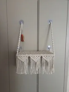 Macrame hanging cat hammock detail, bohemian woven shelf with suction cups for pets.
