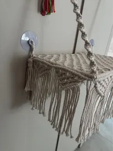 Close-up detail of macrame cat hammock showing woven cotton cord and stylish hanging fringe design.