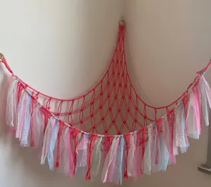 Handmade cotton rope toy hammock corner net with colorful ribbons for kids room.