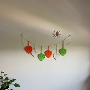 Handmade macrame leaf wall hanging, bohemian cotton rope tassel garland for room decor.