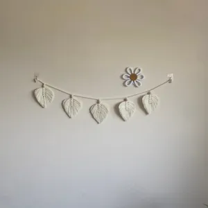 Handmade macrame leaf wall hanging, bohemian cotton woven tassel decor for room view.