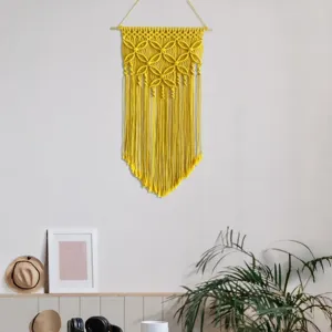 Detailed view of the yellow bohemian macrame wall hanging, showcasing intricate cotton rope knots.