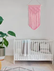 Hand woven bohemian pink cotton rope wall hanging detail shot for nordic home decor aesthetic style.