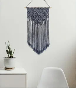 Boho macrame wall hanging detail shot, handmade cotton woven tapestry for cozy home decor.