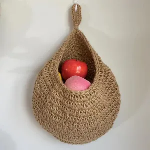 Handmade jute hanging fruit basket, wall mounted woven vegetable pocket for kitchen storage.