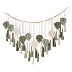 Nordic handmade macrame wall hanging with wooden beads, green leaf tapestry for decor.