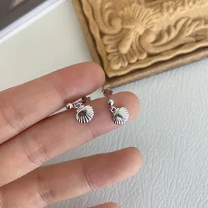 Detaillierte Nahaufnahme von Sterlingsilber Muschel Ohrringen mit feiner Verarbeitung.